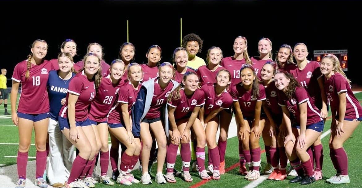 High school girls soccer team posing together for a picture
